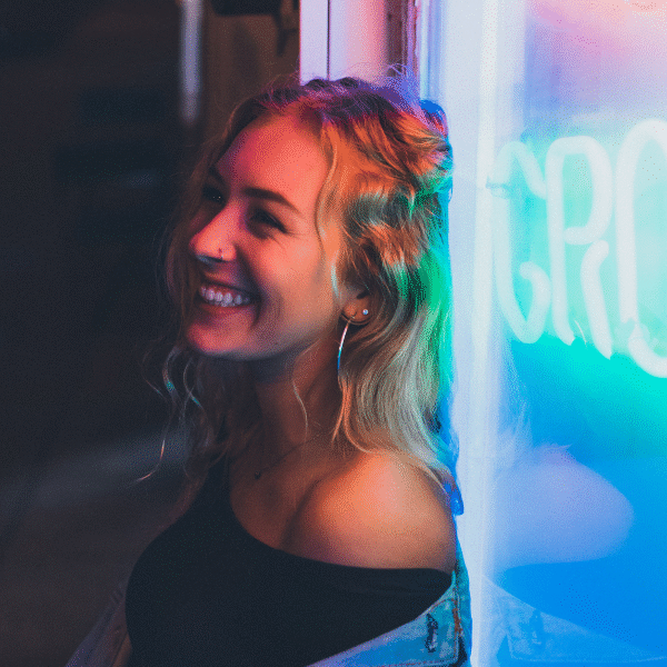 pretty-lady-smiling-next-to-neon-lights