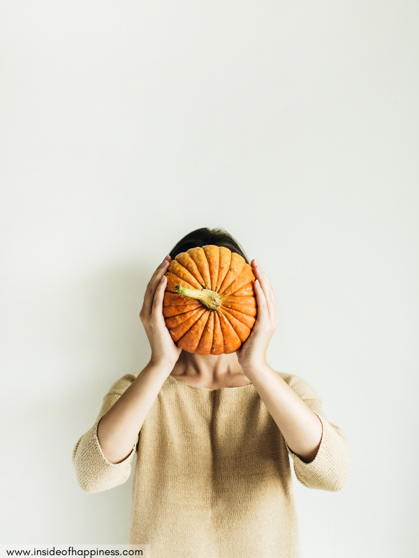 woman-holding-a-pumpkin-on-her-face