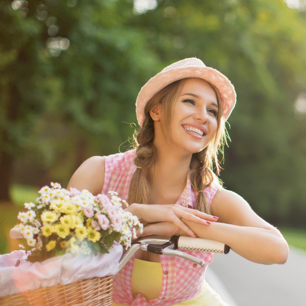 woman-smiling-and-riding-a-bycicle