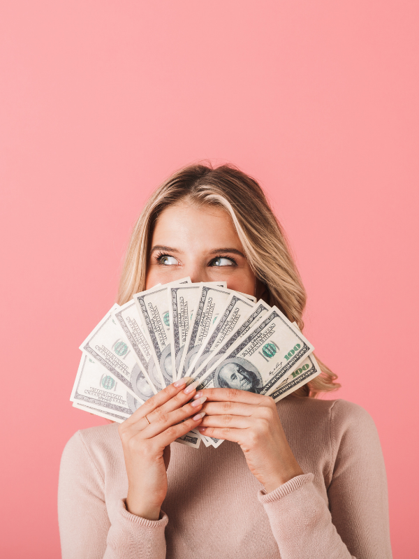 woman-smiling-behind-some-cash-money