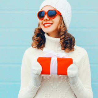 woman-heart-glasses-holding-christmas-gift