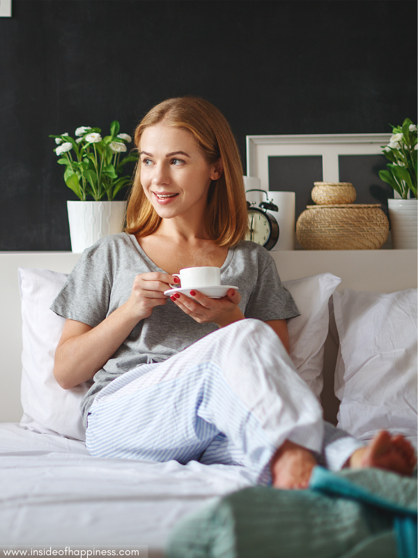 smiling-woman-in-bed-having-morning-coffee