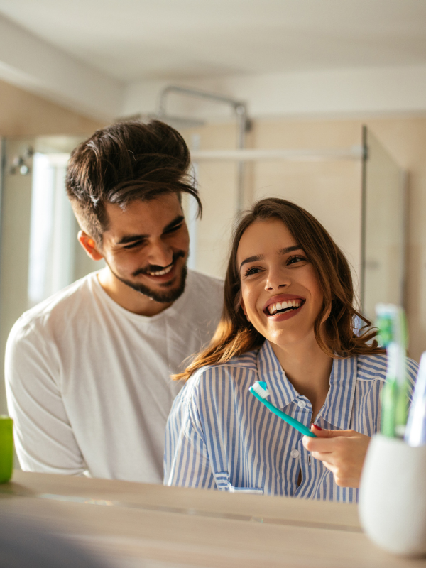 couple-brushing-teeth-and-smiling