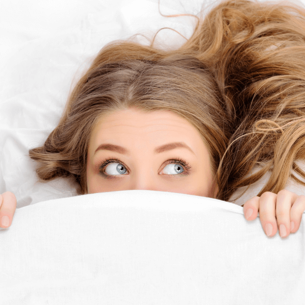 woman-under-white-bedsheets