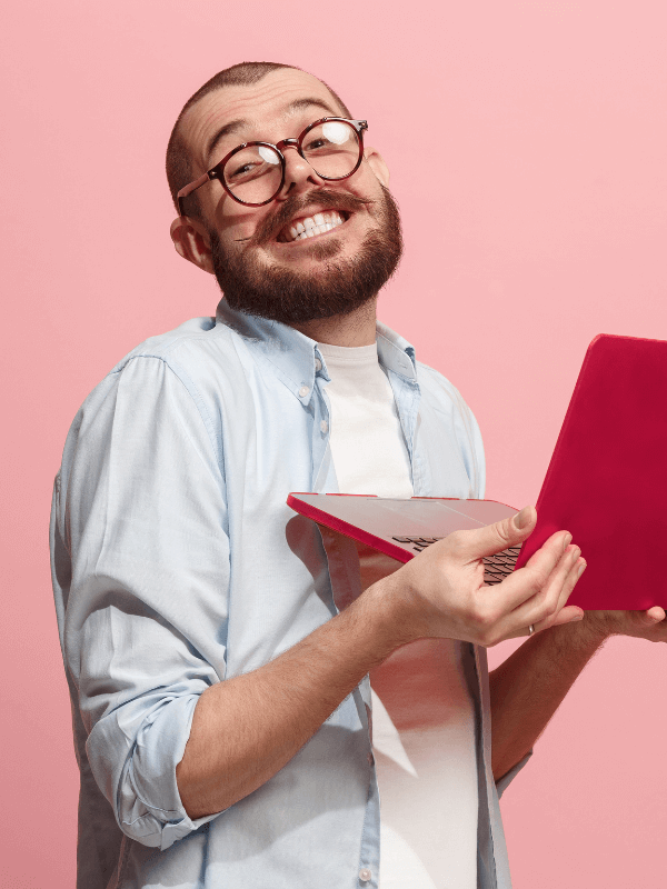 smiling-man-with-a-red-laptop-in-his-hands