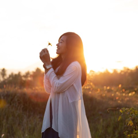 woman smelling a flower