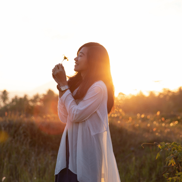 woman smelling a flower