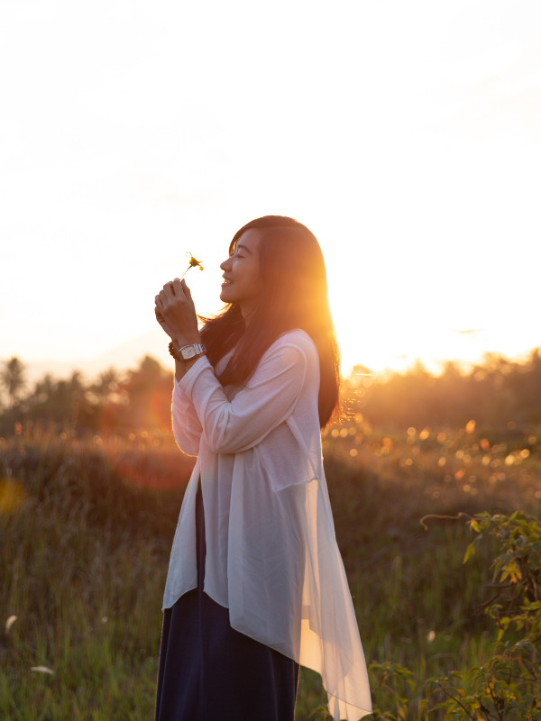 woman smelling a flower
