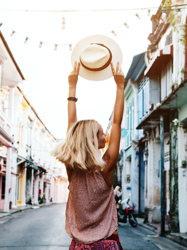 blonde-woman-rising-her-hat-in-the-air