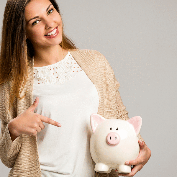 woman showing piggy bank
