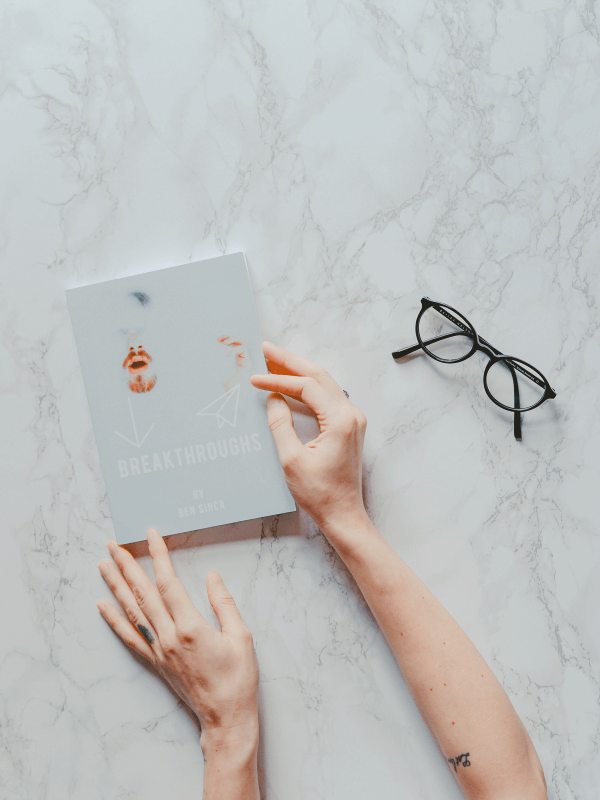 woman-holding-her-hands-on-a-notebook