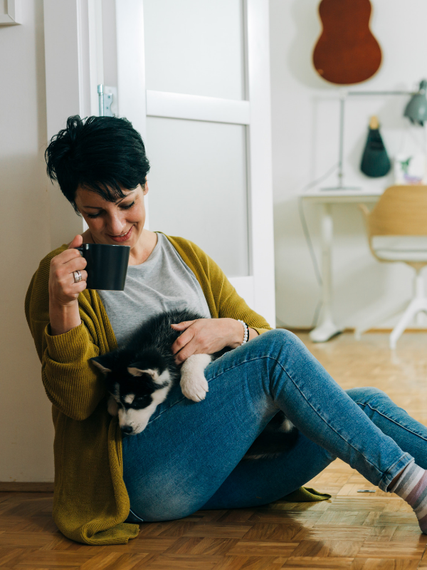 woman cuddling a dog