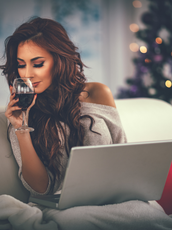 woman sipping wine in a n evening festive dress