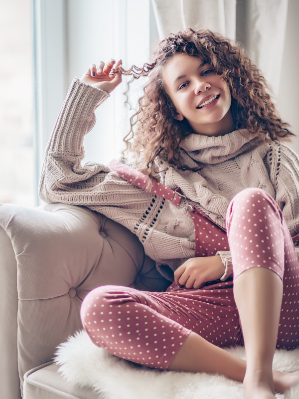 woman sitting on the couch and smiling