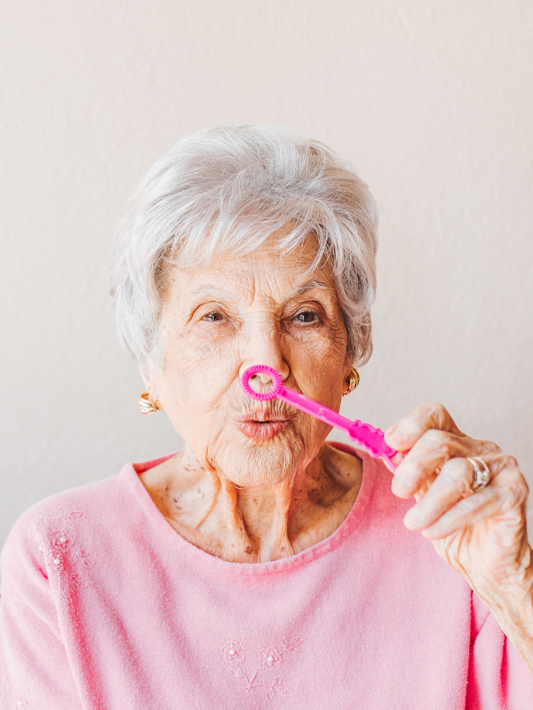 elderly woman dressed in pink