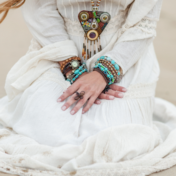 featured photo of a boho woman sitting on the sand