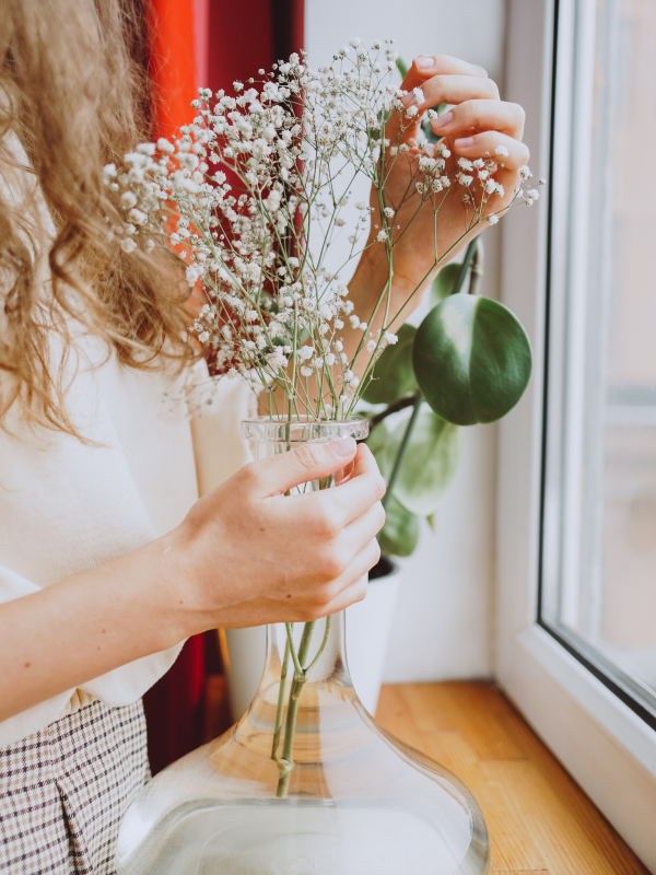 woman arranging white flowers