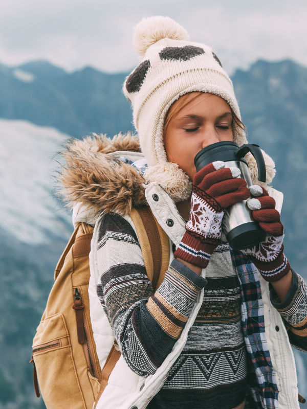 woman sipping warm coffee from a mug