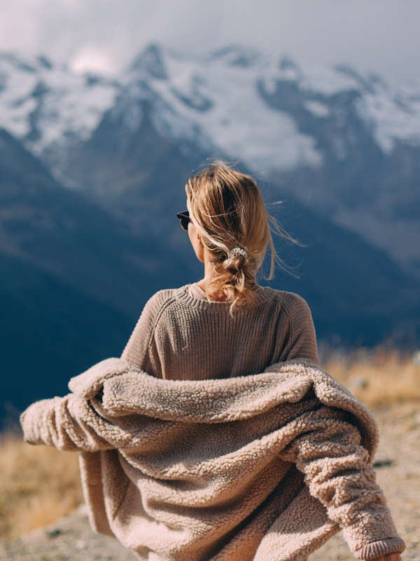 woman walking outdoors enjoying view of the mountain