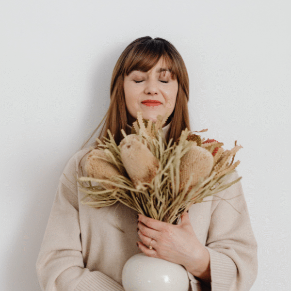 woman holding dry flowers