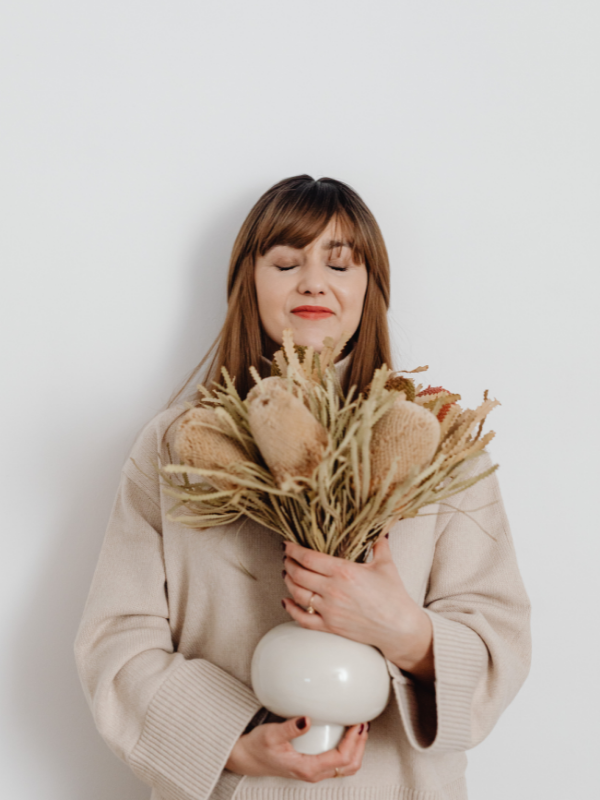 woman holding dry flowers