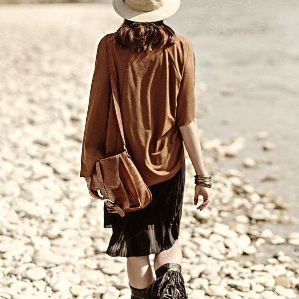 woman walking on the rocks on a beach