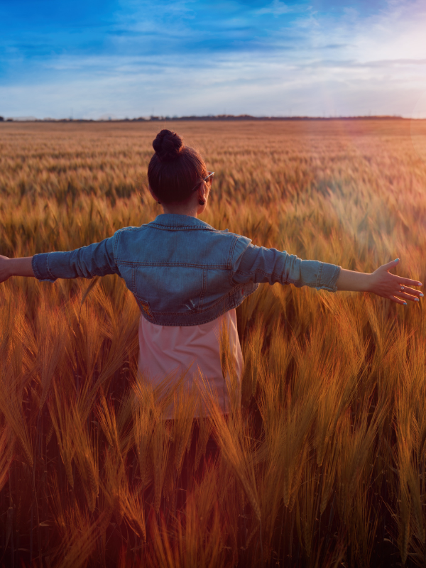 woman with open arms expressing gratitude to the world