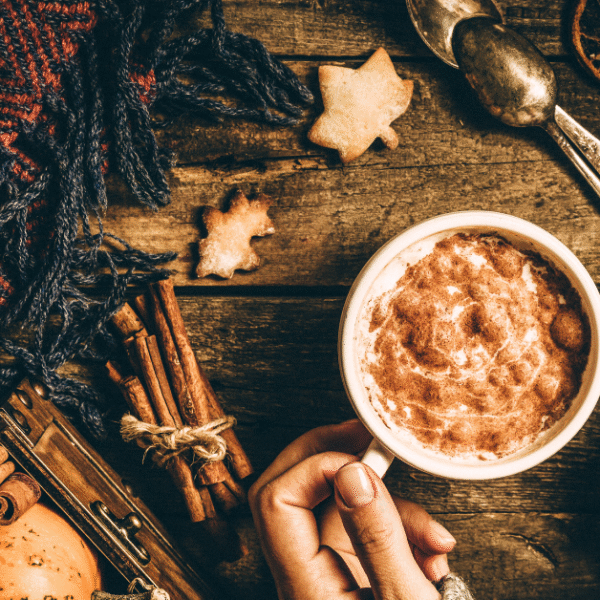 woman's hands holding a cup of hot chocolate
