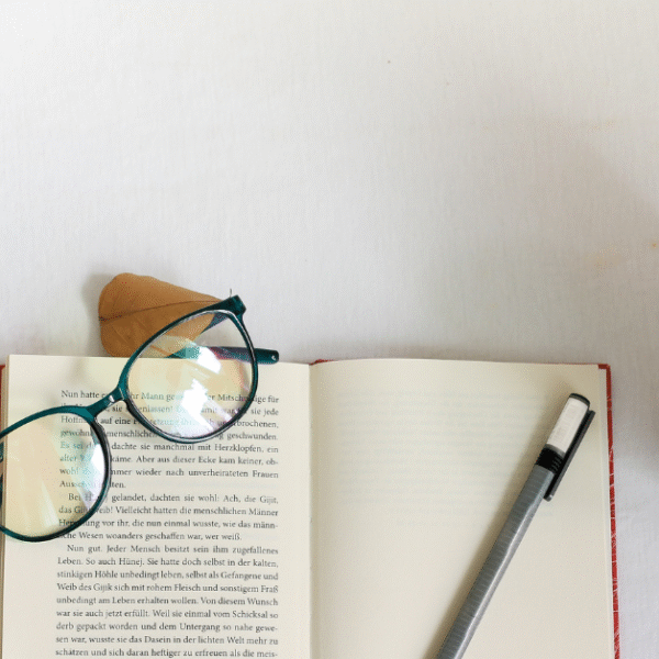 featured photo motivational articles on life with an open book, glasses on top and a coffee mug