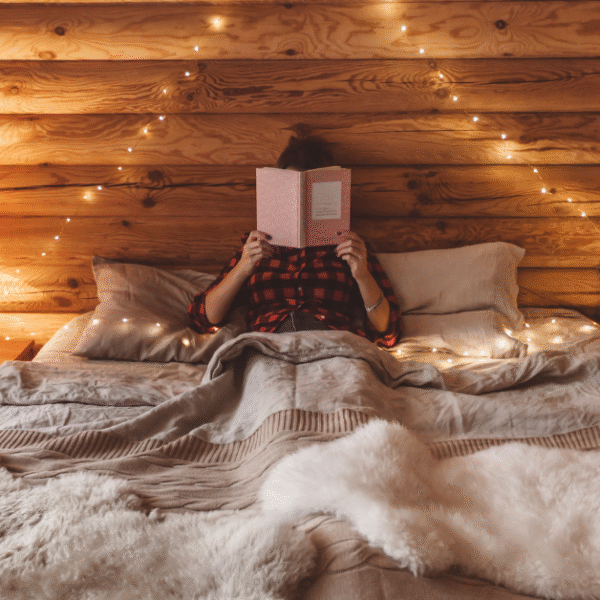 featured photo of a woman in her bed reading a book