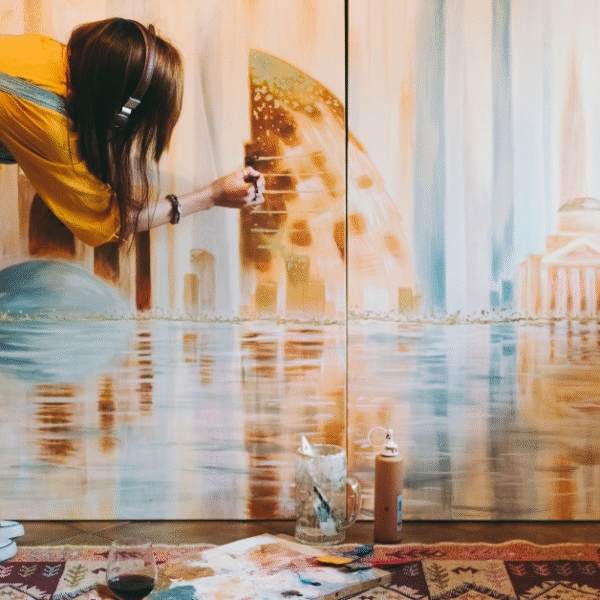 an image of a young woman painting on a wall