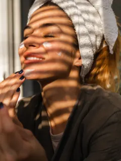 featured image of a woman applying face cream and smiling