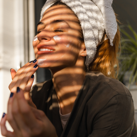 featured image of a woman applying face cream and smiling