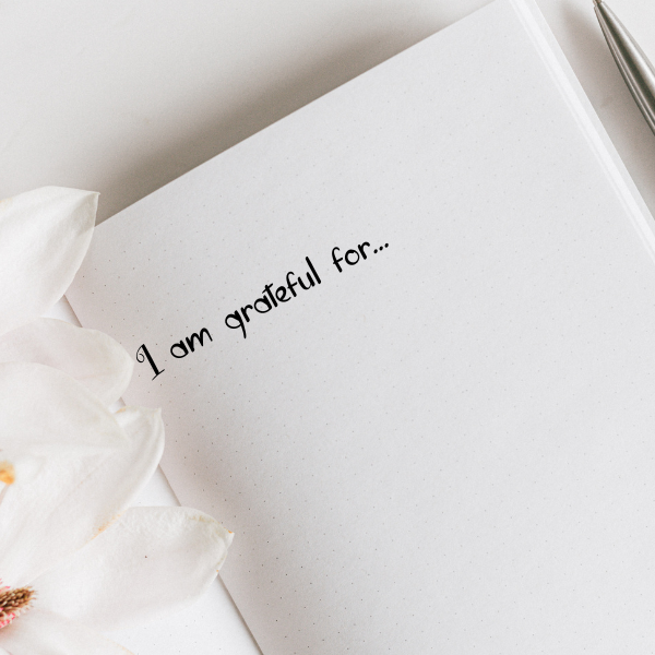 image of an open notebook with a text on top I am grateful for